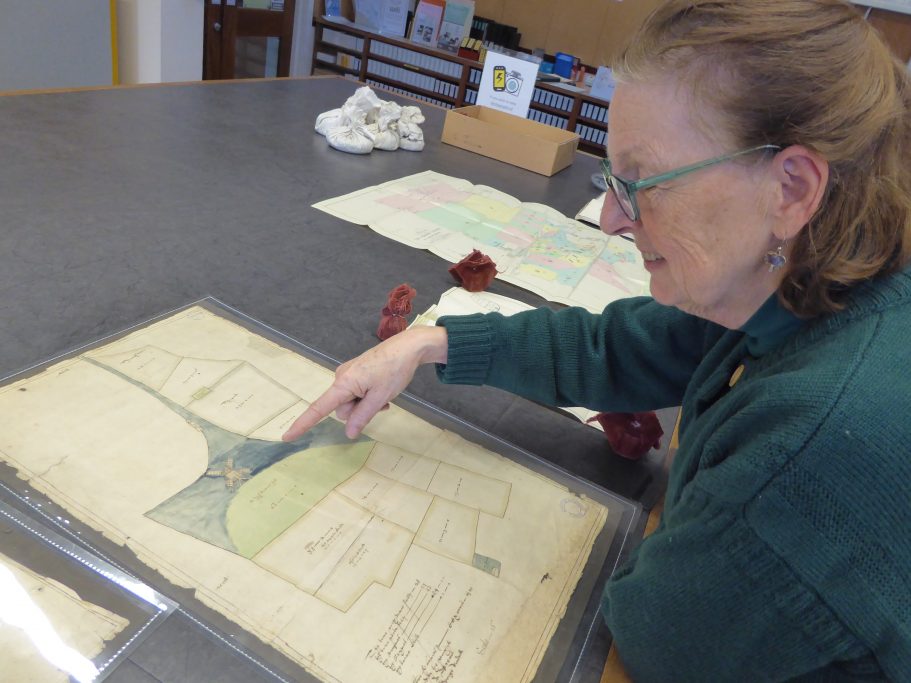 Volunteer with 17th century map of Highdown Feb 2020 by Hamish MacGillivray