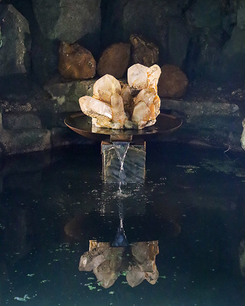 The large Himalayan quartz crystal which now sits in the cave next to the pond